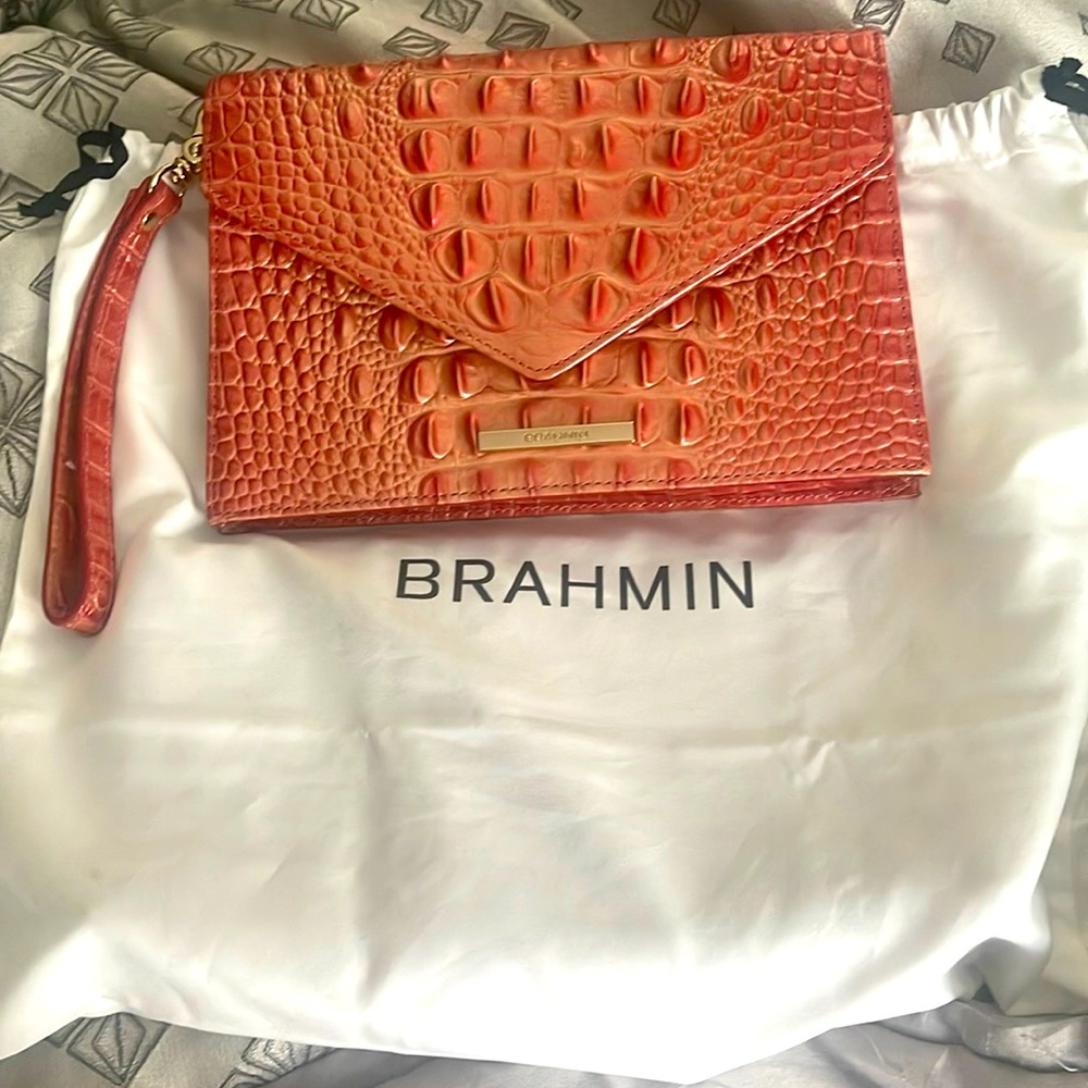 Brahmin Clutch clean on inside no spots has a lil wear n tear on corner of bag